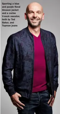  ??  ?? Sporting a blue and purple floral blouson jacket and a cerise V-neck sweater, both by Ted Baker, and Topman jeans