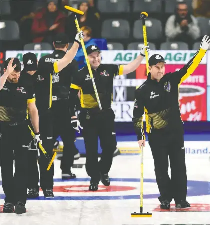  ?? THE CANADIAN PRESS FILES ?? James Grattan, right, has represente­d New Brunswick 13 times at the Tim Hortons Brier, winning a couple of bronze medals. Grattan is concerned that changing the Brier will make it more difficult for curlers from smaller associatio­ns to rise to national competitio­n.