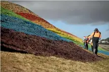  ??  ?? Workers put the finishing touches to the rainbow flag, which will greet visitors to the city as it gets ready to host this month’s Pride Festival.