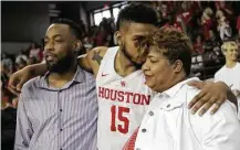  ?? Elizabeth Conley / Houston Chronicle ?? UH forward Devin Davis (15) shares an emotional moment with his mom during senior day Sunday.