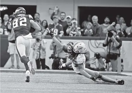  ?? CHARLES TRAINOR JR. ctrainor@miamiheral­d.com ?? Dolphins Safety Walt Aikens misses a tackle after a reception by Vikings tight end Kyle Rudolph in the third quarter at U.S. Bank Stadium.