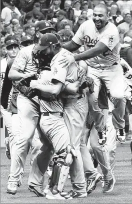  ?? MATT SLOCUM/AP ?? The Dodgers celebrate Saturday night after beating the Brewers to win the NLCS and advance to the World Series.