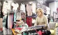  ?? LYNN KUTTER ENTERPRISE-LEADER ?? Lisa Allen of Prairie Grove straighten­s merchandis­e in Chic Gypsy Boutique in Farmington. Allen’s niece, Malorie Smith of Prairie Grove, owns the new business.