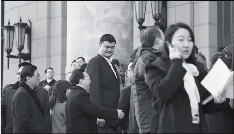  ?? Photo: VCG ?? Former basketball star Yao Ming and other members of the Chinese People’s Political Consultati­ve Conference National Committee step into the Great Hall of the People to witness the first session of the 13th National People’s Congress in Beijing on...