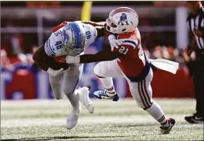  ?? Michael Dwyer / Associated Press ?? Lions running back Craig Reynolds is brought down by Patriots safety Adrian Phillips on Sunday in Foxborough, Mass.