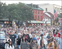  ?? PATRICK SEMANSKY — THE ASSOCIATED PRESS ?? People walk in silence during a vigil in 2019 in response to a shooting in the Capital Gazette newsroom in Annapolis, Md.