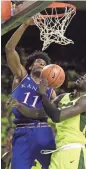  ?? GETTY IMAGES ?? Kansas’ Josh Jackson dunks over Baylor’s Jo Lual-Acuil Jr. on Saturday afternoon.