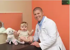  ??  ?? Pediatrici­an Dr. David Butler and patient