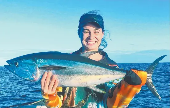  ??  ?? Ashleigh Readett with a 78cm tuna in the Arafura Sea, just off Maningrida