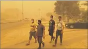  ?? Ali Abdul Hassan Associated Press ?? THE SANDSTORM was Iraq’s fifth in a month. It left Baghdad with low visibility and a blanket of dust.