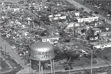  ??  ?? This Aug. 25, 1992, file photo shows the water tower, a landmark in Florida City, Fla., still standing over the ruins of the Florida coastal community that was hit by the force of Hurricane Andrew. Cities like Tampa, Houston, Jacksonvil­le and Daytona...