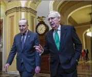  ?? AL DRAGO / THE NEW YORK TIMES ?? Senate Minority Leader Chuck Schumer (left), D-N.Y., and Majority Leader Mitch McConnell, R-Ky., leave McConnell’s office Wednesday after budget discussion­s on Capitol Hill.