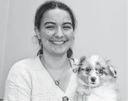  ?? LYNN CURWIN ?? Carrie Lucas recently spent some time cuddling a 10-week-old Australian shepherd pup. Lucas is one of the handlers who will be taking part in the Cobequid Dog Club Show April 27-28.