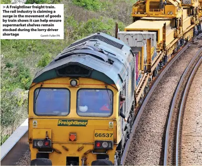  ?? Gareth Fuller/PA ?? > A Freightlin­er freight train. The rail industry is claiming a surge in the movement of goods by train shows it can help ensure supermarke­t shelves remain stocked during the lorry driver shortage