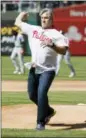  ?? CHRIS SZAGOLA - AP ?? Philadelph­ia Eagles head coach Doug Pederson, wearing a Roy Halladay jersey, throws out the ceremonial first pitch prior to Thursday’s home opener against the Miami Marlins in Philadelph­ia.