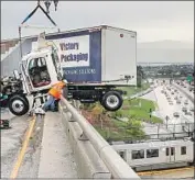  ?? Irfan Khan Los Angeles Times ?? A BIG RIG hangs over the 710-60 freeway connector in East L.A. as rain soaked the morning rush hour.