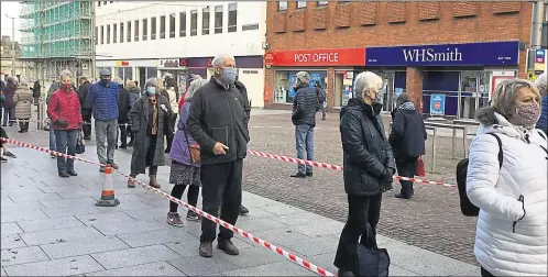  ?? Picture: Anne Smyth ?? People queuing outside the ex-Debenhams in Folkestone waiting for their Covid-19 jab