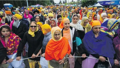  ?? JASON PAYNE/PNG ?? The Vaisakhi parade in Surrey attracts hundreds of thousands of people. The parade, the largest of its kind outside of India, is an important cultural event for Sikhs. Much of what makes Sikhism authentic revolves around service to community.