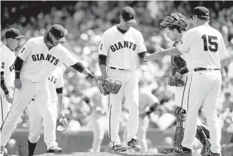  ?? JIM GENSHEIMER/STAFF ?? Relief pitcher Javier Lopez hands over the ball to Giants manager Bruce Bochy in the ninth inning against the Cincinnati Reds at AT&T Park on Wednesday.