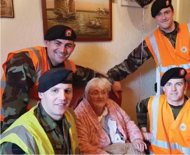  ??  ?? Roundwood woman Maura Doyle, who was dug out by troops from the 7th Infantry bn Lt Richard O’Hagan, Cpl Wayne Casey, Pte Mick McCabe, Pte Gareth Callaghan, and Pte Paul Keane, who called back with a cake and card to celebrate her 100th birthday the...