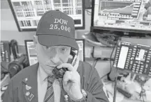  ?? Mark Lennihan / Associated Press ?? Vincent Pepe, a commoditie­s broker, wore a celebrator­y hat to work at the New York Stock Exchange on Thursday.