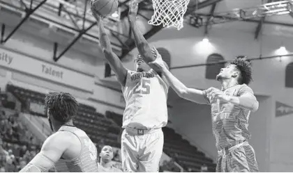  ?? SCOTT AUDETTE/AP ?? Maryland’s Jalen Smith (25) drives past Marquette’s Brendan Bailey in the first half of Sunday’s victory to win the Orlando Invitation­al.