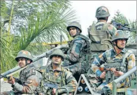  ?? NITIN KANOTRA/HT ?? Security personnel take position during an encounter with terrorists at Sunjuwan military station in Jammu on Sunday. Five soldiers and a civilian died in the attack on an army camp.