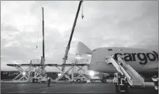  ?? PASCAL LAUENER / REUTERS ?? A Cargolux Boeing 747 cargo plane is loaded at Payerne airport. Henan Civil Aviation Developmen­t and Investment Co Ltd bought a 35 percent stake in Cargolux Airlines Internatio­nal SAS for $231 million.