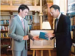  ??  ?? DUBLIN: Prime Minister Justin Trudeau, left, and Irish Taoiseach Leo Varadkar exchange gifts during their meeting at Farmleigh House. —AP