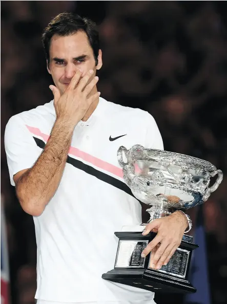  ?? SAEED KHAN / AFP / GETTY IMAGES ?? Roger Federer breaks down in tears after winning his sixth Australian Open title Sunday, matching Novak Djokovic and Roy Emerson for most men’s singles championsh­ips at Melbourne Park.