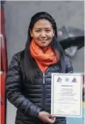  ??  ?? This photo taken on January 4, 2018 shows Nepali mountain guide Dawa Yangzum Sherpa posing with a mountainee­ring certificat­e in Kathmandu.