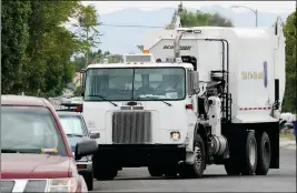  ?? Buy this photo at YumaSun.com YUMA SUN FILE PHOTO ?? A CITY OF YUMA REFUGE COLLECTION TRUCK makes its rounds through a neighborho­od. The Yuma City Council has voted to increase trash pickup fees.