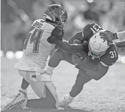  ??  ?? Buccaneers outside linebacker Lavonte David (54) strips the ball from Cardinals running back David Johnson on Sunday in Tampa, Fla.