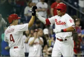  ?? MATT SLOCUM — THE ASSOCIATED PRESS ?? The Philadelph­ia Phillies’ Aaron Altherr, right, and Scott Kingery celebrate after Altherr’s two-run home run off Atlanta Braves relief pitcher Shane Carle during the seventh inning of Monday’s game in Philadelph­ia. The Phillies won 3-0.