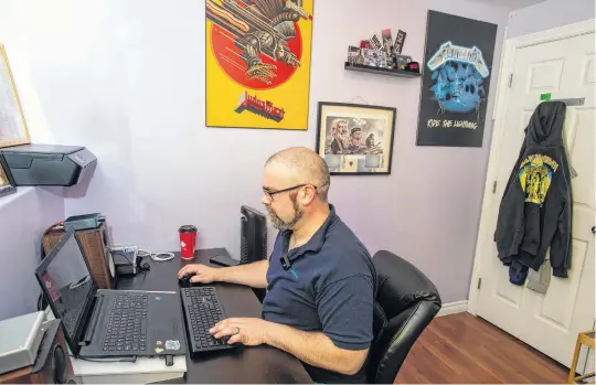  ?? RYAN TAPLIN • THE CHRONICLE HERALD ?? With heavy metal posters on the wall next to him, Kyle Davis, communicat­ions co-ordinator with Admiral Insurance, works in his home office in Eastern Passage.