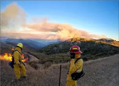  ?? COURTESY PHOTO IMPERIAL COUNTY FIREFIGHTE­R’S ASSOCIATIO­N ?? Wildland firefighte­rs assigned to the Imperial Valley Strike Force under the command of Chief Alex Silva keep a wary eye on a patch of fire while fighting the Mendocino Complex Fires earlier this week.