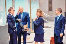  ?? ANDRES KUDACKI/ASSOCIATED PRESS ?? Attorney Joanna Hendon, second from right, representi­ng President Donald Trump, talks to Michael Avenatti, second from left, attorney for adult film actress Stormy Daniels, at federal court on Friday.