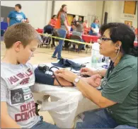  ??  ?? Daniel Harbin, 10, of Judsonia has his blood pressure checked by Julissa Lynn of Unity Health.