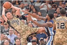  ?? DARREN ABATE/AP ?? Spurs guard Manu Ginobili (20) looks to pass to LaMarcus Aldridge (12) as Memphis forward Troy Daniels (30) guards the play Thursday in San Antonio.