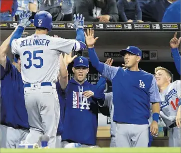  ?? Alex Gallardo Associated Press ?? DODGERS PLAYERS congratula­te Cody Bellinger after he hit a three-run home run, his second of the game, against San Diego on Friday. Bellinger is tied for the team lead in home runs this season with five.