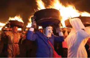  ?? EPA-EFE African News Agency (ANA) ?? PEOPLE parade through the streets of Allendale, UK, with barrels of burning tar on New Year’s Eve. The tradition dates back to 1858, and the barrels are used to light a bonfire at midnight. |