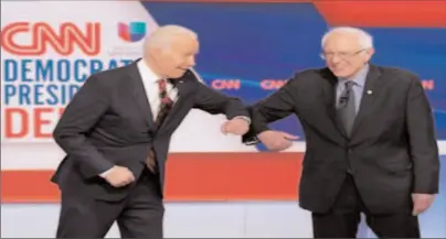  ?? WASHINGTON
-AP ?? Democratic presidenti­al hopefuls former US vice president Joe Biden (L) and Senator Bernie Sanders greeted each other with an elbow bump at the start of the Democratic Party 2020 presidenti­al debate.