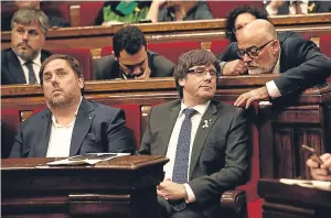  ??  ?? Catalan regional president Carles Puigdemont, centre, in the parliament.