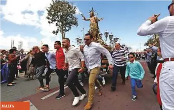  ?? Reuters ?? AP SOUTH KOREA MALTA ■ Worshipper­s carrying a statue of the Risen Christ run during an Easter Sunday procession in Cospicua, Malta, yesterday.