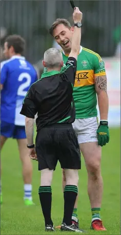  ??  ?? Conor Crawley’s game is over as referee Stephen Johnson issues him with a black card.