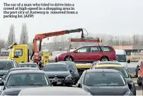  ??  ?? The car of a man who tried to drive into a crowd at high-speed in a shopping area in the port city of Antwerp is removed from a parking lot. (AFP)