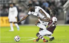  ?? RON CHENOY/USA TODAY ?? The Whitecaps’ Tony Tchani and the Rapids’ Michael Azira battle for the ball in Commerce City, Colo., on Friday.