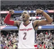  ?? ALEX BRANDON / AP ?? Wizards guard John Wall celebrates after hitting a go-ahead 3-pointer late in the fourth quarter Friday, forcing a Game 7 Monday in Boston.