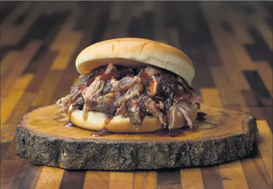  ?? COURTESY OF THE SHED BARBECUE & BLUES JOINT ?? David Page’s book “Food Americana” covers the history of the U.S. palate, including elements like the evolution of barbecue. Shown is a pulled pork sandwich made in Mississipp­i.