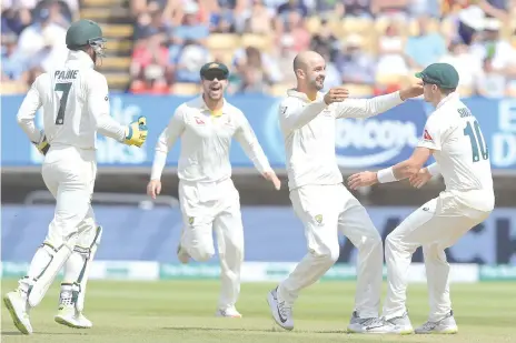  ??  ?? Australia's Nathan Lyon (2nd R) celebrates with teammates after taking the wicket of England's captain Joe Root during play on the fifth day of the first Ashes cricket Test match between England and Australia. - AFP photo